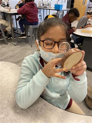 student using magnifying glass 